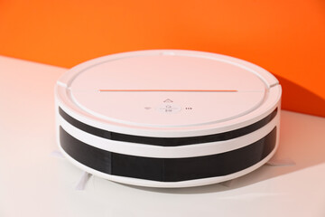 Cordless vacuum cleaner on orange background, close up