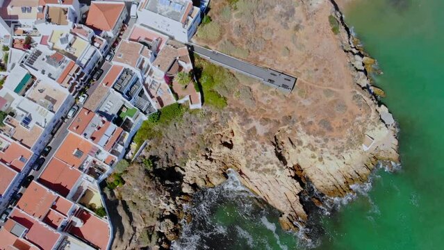 Drone topshot from the coast where cliffs devide town and sea.