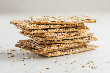 Knackebrot with sesame seeds. Wholegrain crispbread on kitchen table.