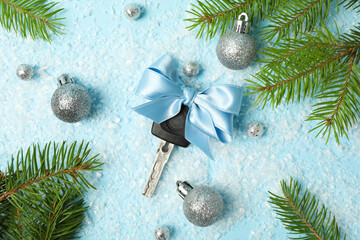 Car key with a bow with Christmas decorations.