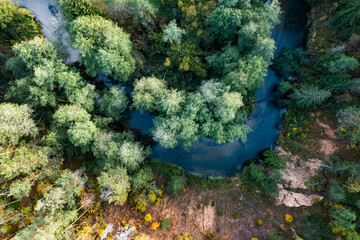 river bend in the middle of forest, autumn colour woodland