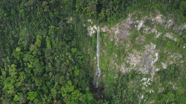 Aerial retreat from beautiful tall jungle waterfall, Cascada el Bejuco