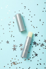 Lip balm on blue background, top view