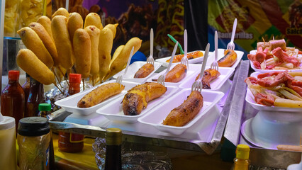 Fast food stand in Mexico. Ripe plantains, sausages, potatoes.