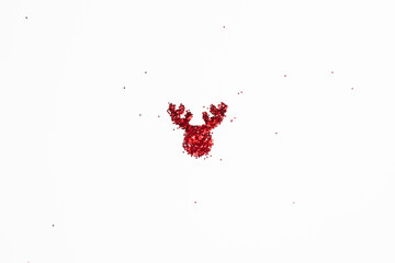 The shape of a reindeer's head of shiny colorful red glitter on white background with copy space,