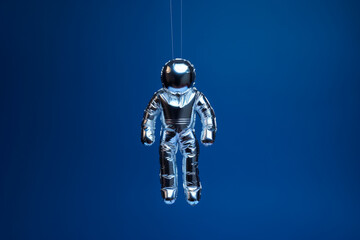 space themed birthday party: astronaut shaped foil balloon on a dark blue background