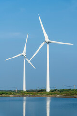 Close-up of wind power systems with the blue sky background.