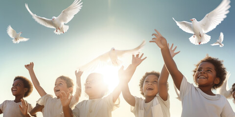Group of multi ethnic children releasing a white doves to fly in the air. Symbol of freedom and peace. Peace in the world concept - obrazy, fototapety, plakaty
