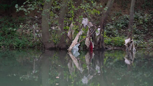 Garbage and plastic waste on water - (4K)