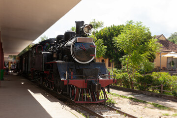 Old retro steam railway train station on sunny day
