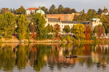 Fototapeta premium Autumn views from Prague. Picturesque autumn Prague in the morning sun. The Vltava River with the Charles Bridge, the waterfront and houses of Mala Strana and the dominant Prague Castle. Czechia