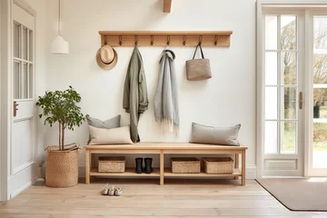 Fotobehang Scandinavian entrance of the home with functional hooks for coats, a wooden bench for sitting, a mirror for last-minute checks, and baskets for storing shoes © GustavsMD