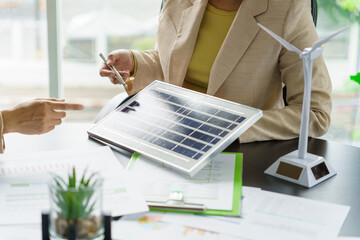 Solar panels green energy Business people working in green eco friendly office business...
