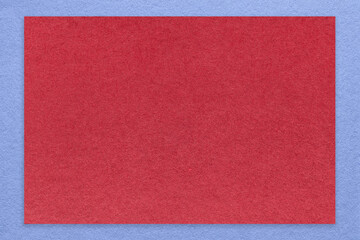 Texture of craft red color paper background with blue border, macro. Vintage dense kraft wine cardboard