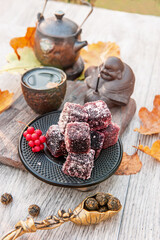 Homemade fruit marmalade from assorted berries with tea on the table in the garden