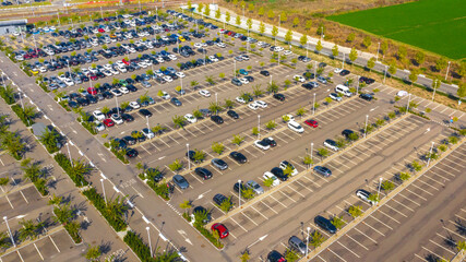 Aerial view of the Reggio Emilia AV Mediopadana station car park. There are many cars parked but...