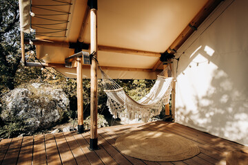 Hammock for rest and relaxation on the veranda overlooking the forest and mountains. Camping...