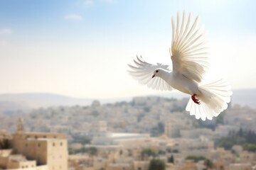 A white peace dove flying against a blue sky above a middle east city