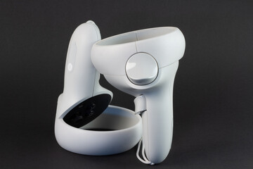 White vr controller on black background. © ED