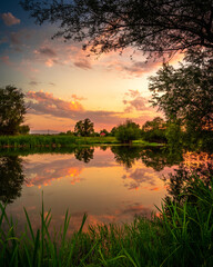 Fototapeta na wymiar A beautiful sunset over the calm river in Bulgaria.
