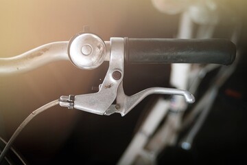 Close up of bicycle handlebar with blur background, vintage tone.