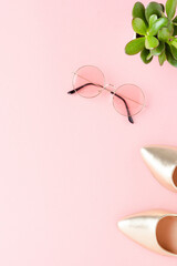 Golden high heels with sunglasses. Fashion background