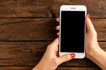 Woman’s hands using smart phone with empty screen