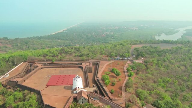 Goa, India: Aerial view of Indian summer resort by Arabian Sea, famous landmark and tourist attraction Fort Aguada - landscape panorama of South Asia from above