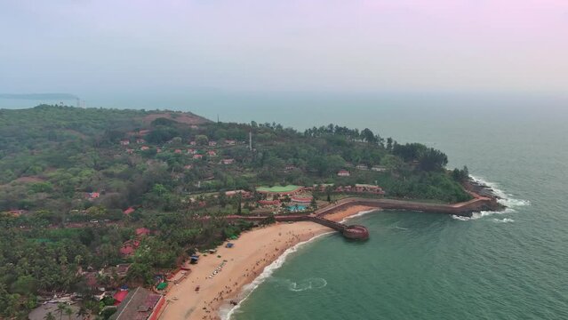 Goa, India: Aerial view of famous Indian summer resort by Arabian Sea, famous Sinquerim Beach and Sinquerim Fort at sunset - landscape panorama of South Asia from above
