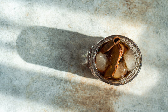 Apple cider cocktail with dried apple slices and a cinnamon stick