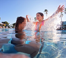 Mother teaching daughter to swim in pool during summer vacation. Mother and daughter playing in water. Beach resort vacation by the sea. Winter or summer seaside holiday.