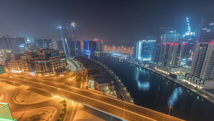 Skyscrapers at the Business Bay aerial night timelapse in Dubai, United Arab Emirates