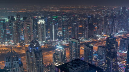 Obraz premium JLT and Dubai marina skyscrapers near Sheikh Zayed Road aerial day to night timelapse. Residential buildings
