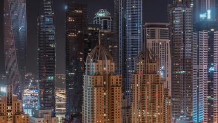Fototapeta na wymiar Skyscrapers of Dubai Marina with highest residential buildings all night timelapse