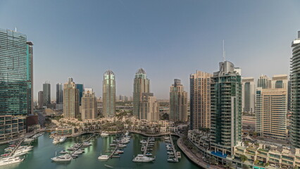 Fototapeta na wymiar Panorama showing Dubai marina tallest skyscrapers and yachts in harbor aerial timelapse.