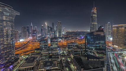 Panorama showing futuristic Dubai Downtown and finansial district skyline aerial night timelapse.
