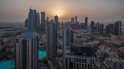 Fototapeta premium Aerial panoramic view of a big futuristic city night to day timelapse. Business bay and Downtown