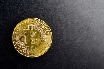 Top view of bitcoin on dark background with text space
