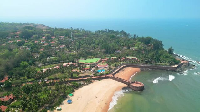 Goa, India: Aerial view of Indian summer resort by Arabian Sea, famous Sinquerim Beach and Sinquerim Fort - landscape panorama of South Asia from above