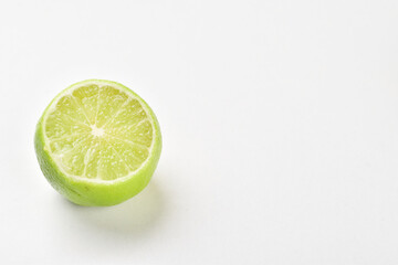 Top cut green lemon on white background with text space 