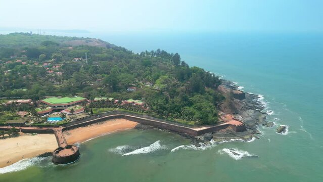 Goa, India: Aerial view of Indian summer resort by Arabian Sea, famous Sinquerim Beach and Sinquerim Fort - landscape panorama of South Asia from above