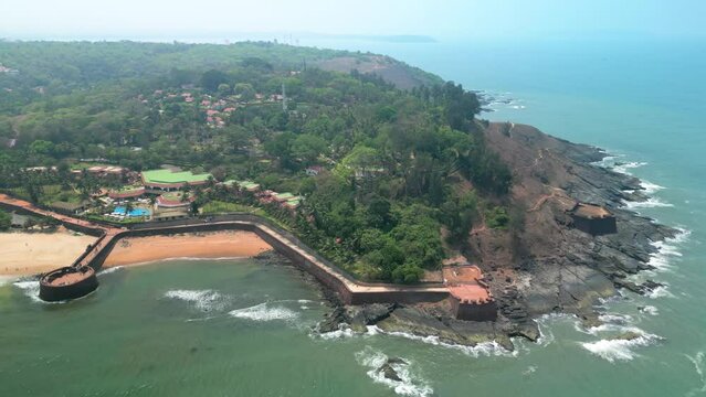 Goa, India: Aerial view of Indian summer resort by Arabian Sea, famous Sinquerim Beach and Sinquerim Fort - landscape panorama of South Asia from above