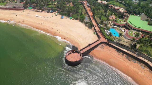 Goa, India: Aerial view of Indian summer resort by Arabian Sea, famous Sinquerim Beach and Sinquerim Fort - landscape panorama of South Asia from above
