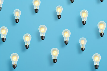 light bulbs pattern on a blue background flat lay
