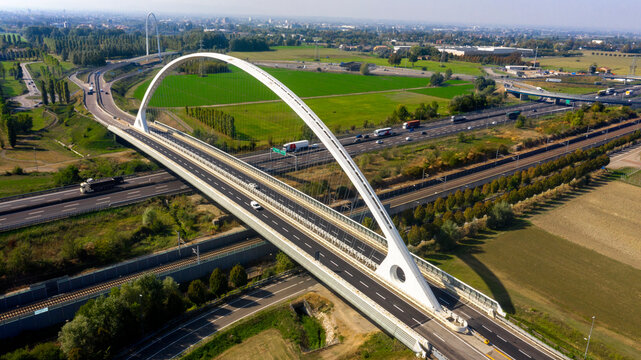 Aerial view of the Calatrava bridge in Reggio Emilia, Italy. The bridge is located along the A1 highway and was designed by Santiago Calatrava. Reggio Emilia, Italy - October, 2023