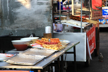 In the market, there are ready-to-sell trays of sausage-filled meatballs.