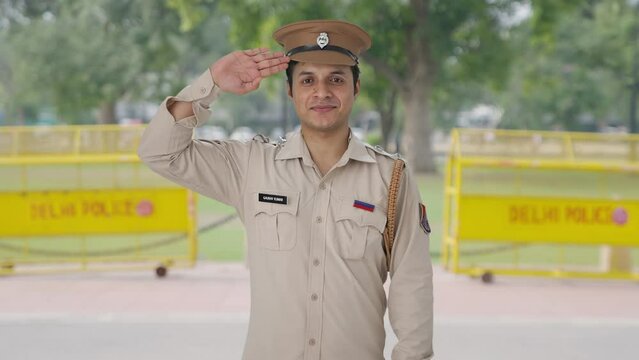 Happy Indian police officer saluting
