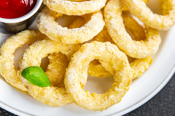 onion rings in batter deep fryer tomato sauce fast food delicious eating cooking appetizer meal food snack on the table copy space