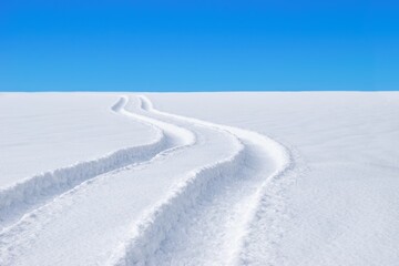 Car tracks in the deep fresh snow, winter landscape.