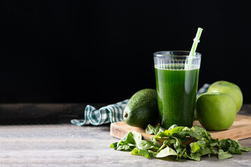 Green smoothie detox with Kale, avocado and apples on wooden table. Copy space